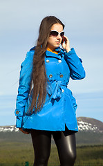 Image showing The modern woman talking on a cell phone for a walk