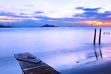 Image showing Sunset along a wooden pier