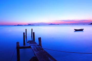 Image showing Sunset along a wooden pier at magic hour