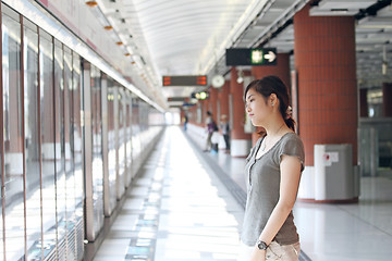 Image showing Asian woman waiting for train