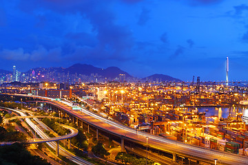 Image showing Busy traffic in Hong Kong at night with container terminal backg