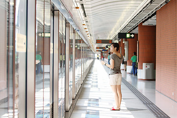 Image showing Asian woman waiting for train 