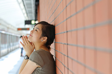 Image showing Asian woman waiting for train with smile