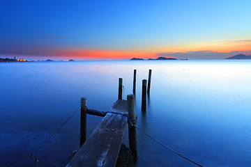 Image showing Sunset at dusk along a wooden pier, high saturation image.