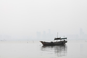 Image showing Lonely boat on the sea in black and white toned