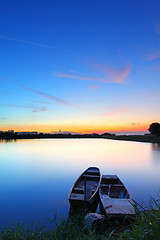 Image showing Sunset along the pond with two boats