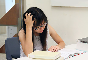 Image showing Asian girl student reading and studying in library