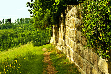 Image showing park bench at an old antique abbey wall