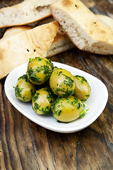 Image showing green olives with fresh bread and herbs