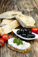 Image showing green olives with fresh bread and herbs