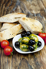 Image showing green olives with fresh bread and herbs