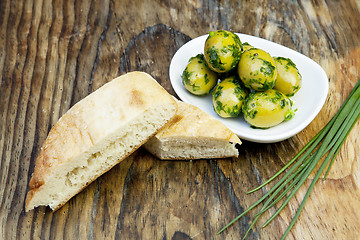 Image showing green olives with fresh bread and herbs