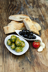 Image showing green olives with fresh bread and herbs