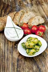 Image showing green olives with fresh bread and herbs