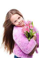 Image showing beautiful  little girl with bouquet of pink tulips isolated on white