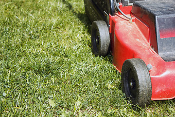 Image showing detail of lawnmower on green grass