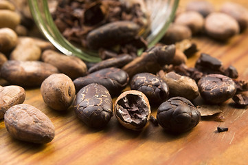 Image showing Cocoa (cacao) beans on natural wooden table