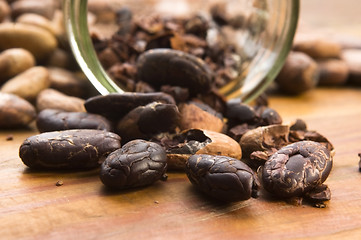 Image showing Cocoa (cacao) beans on natural wooden table