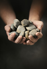 Image showing Hands full of rocks