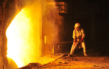 Image showing worker takes a sample at steel company 