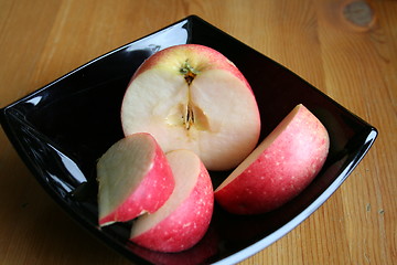 Image showing Apple on black plate