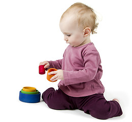 Image showing young child playing with colorful toy blocks