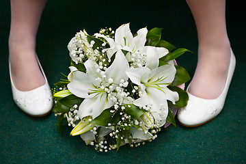 Image showing Bridal bouquet and bride's feet