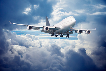 Image showing Aircraft is going for landing. Against cloudy sky