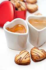 Image showing heart shaped cream cookies on red heart metal box and coffee