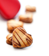 Image showing heart shaped cream cookies on red heart metal box