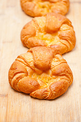 Image showing fresh baked french croissant brioche on wood board