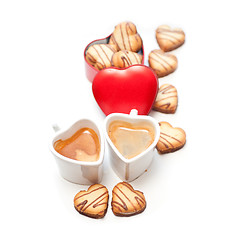 Image showing heart shaped cream cookies on red heart metal box and coffee