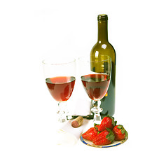 Image showing red wine bottle and two glasses with strawberries