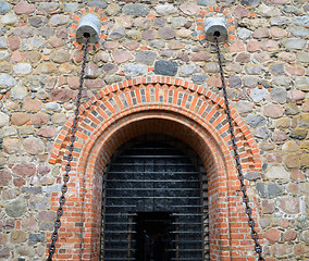 Image showing Entrance to hall of castle gates hang on chains 