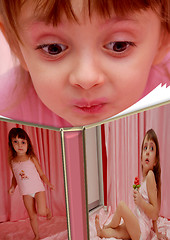 Image showing little girl considering an album