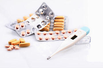 Image showing Thermometer and pills isolated on white