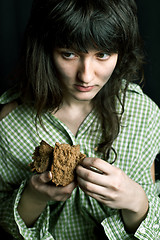 Image showing poor beggar woman with a piece of bread