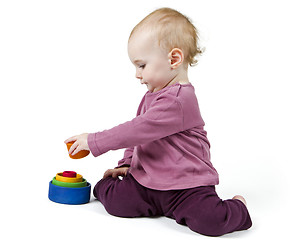 Image showing young child playing with colorful toy blocks