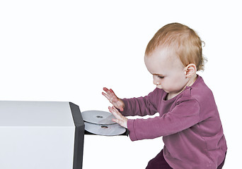 Image showing young child playing with CD