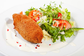 Image showing garlic chicken kiev with mixed leaf salad