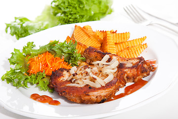 Image showing steak served with sauteed onions, salad and baked potato