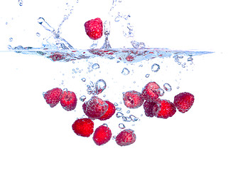 Image showing Red Raspberries Falls under Water with a Splash