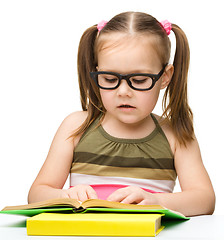 Image showing Cute little girl reading book