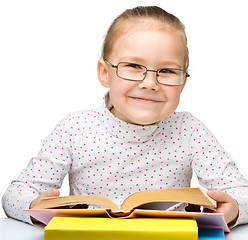 Image showing Cute little girl reading book