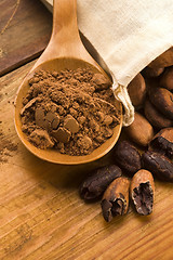 Image showing Cocoa (cacao) beans on natural wooden table