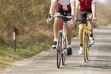 Image showing Male Athletes Riding Bicycles