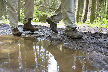 Image showing Hikers Walking Through Mud Puddle