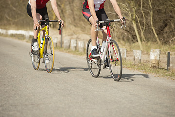 Image showing Male Athletes Riding Bicycles