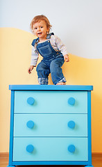 Image showing Toddler jumping from furniture