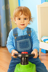 Image showing Portrait of a boy riding a toy car